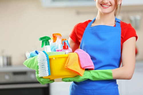 Staff member handling cleaning materials with care and training