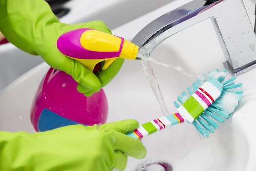 Cleaner maintaining a living room in Hackney