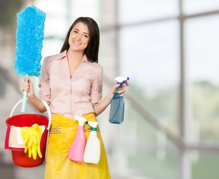 Professional cleaner working in a Hackney kitchen and living area